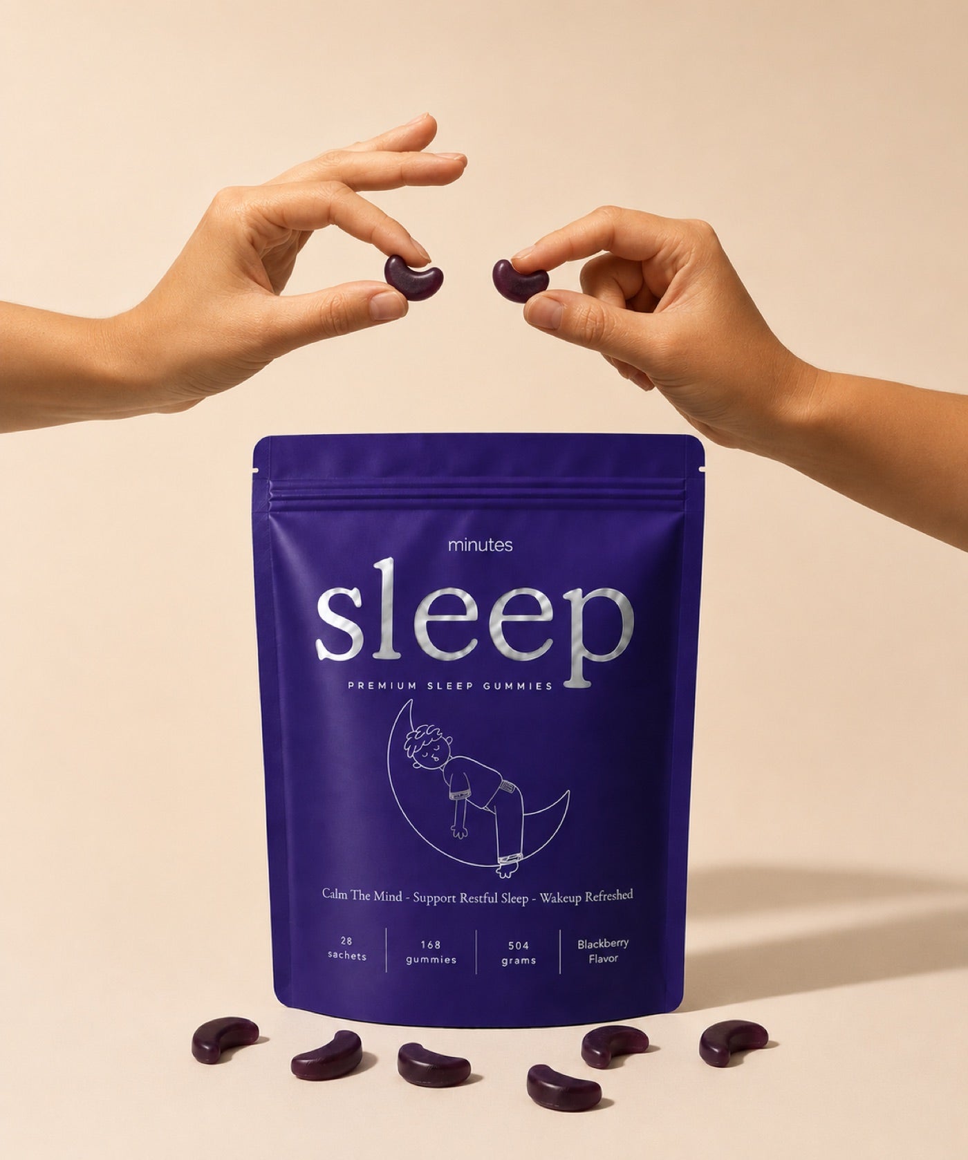 Two hands holding blackberry gummies above the Minutes sleep bag